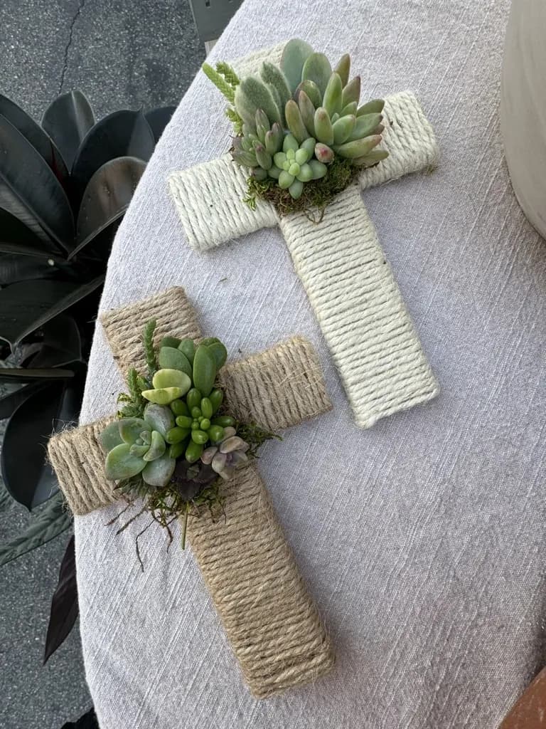 Two twine-wrapped crosses decorated with succulents