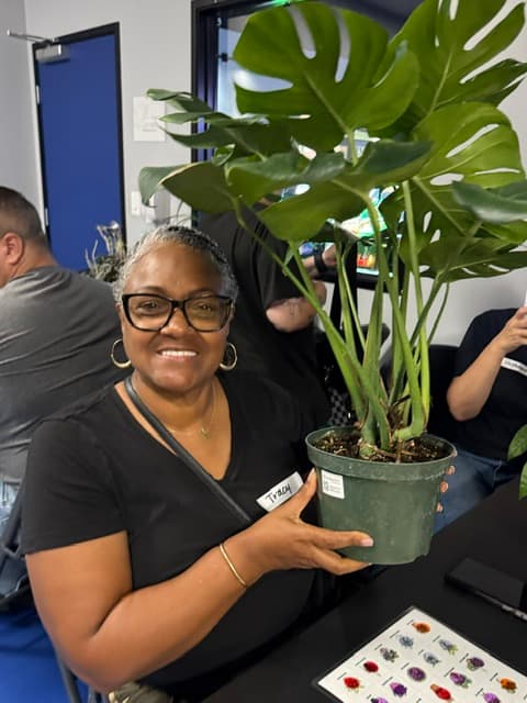Tracy, a Plant Bingo winner, holding her prize monstera