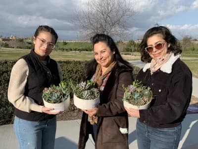 Three friends with the succulent bowls they made together