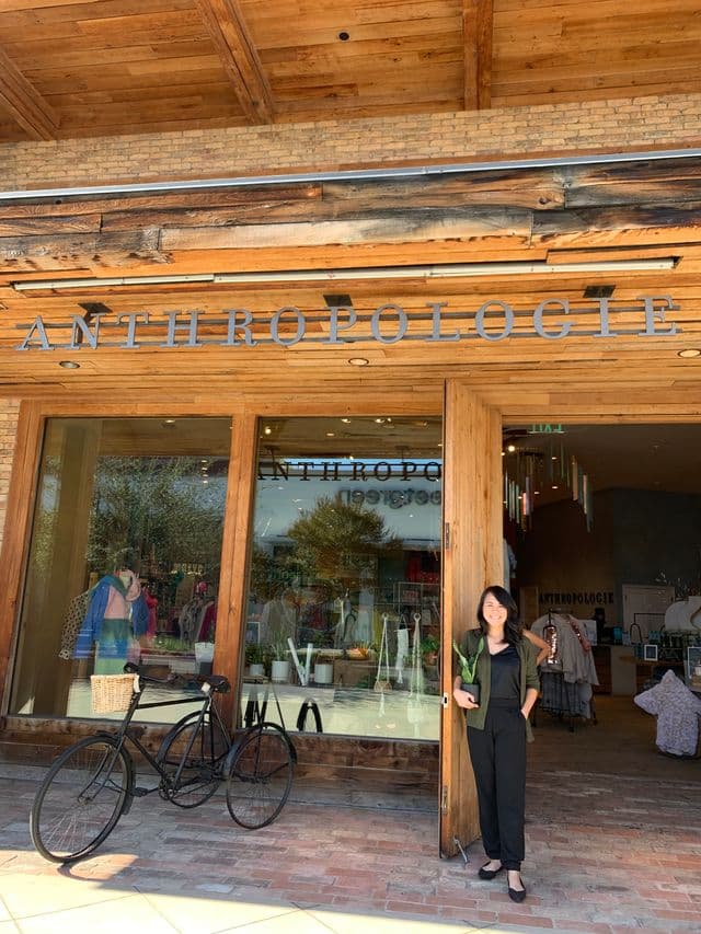 Woman holding a plant at the entrance of Anthropologie